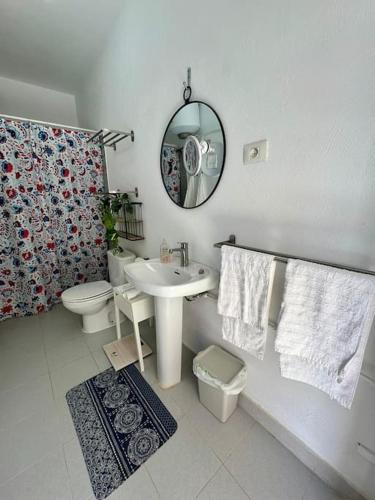a bathroom with a sink and a toilet and a mirror at La dolce vita in Mala