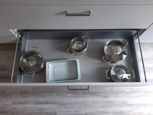 a stove top with pots and a tv on it at FEWO Happe in Lennestadt