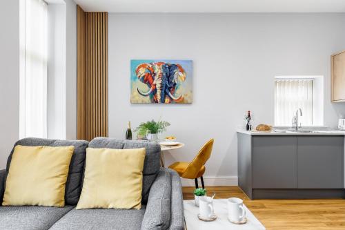 a living room with a gray couch with yellow pillows at Sea Breeze - Coast in Bournemouth