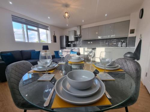 a dining room table with plates and wine glasses at 2 bedroom central apartment near station in London