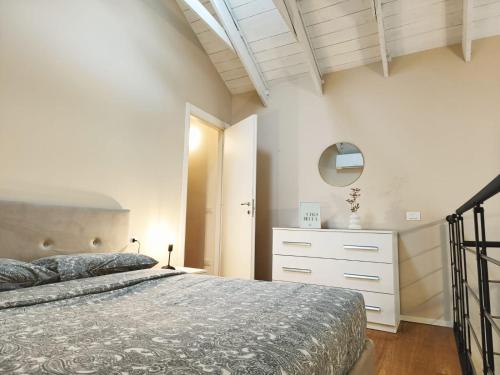 a bedroom with a bed and a dresser in it at YR Apartments Milan - Bocconi - Fashion Apartment in Milan