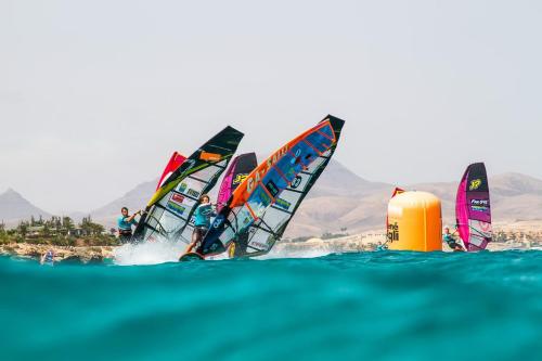 a group of people windsurfing on the water at Casagrande Sunset II - Fuerteventura - Costa Calma in Pájara
