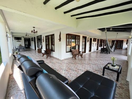 a living room with a couch and a swing at Palmeras del Mirador - Hotel Boutique Campestre en La Vega a 1h de Bogotá in La Vega