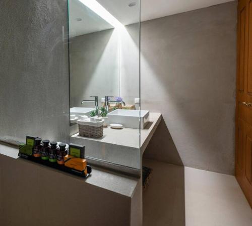 a bathroom with a counter with a sink and a mirror at Traditional cosy chalet in Livadi in Kalívia