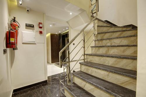 a staircase in a room with a fire extinguisher at BLESS INN - Near Connaught Place in New Delhi