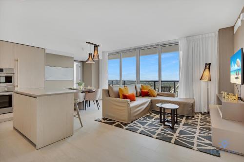 a kitchen and living room with a couch and a table at Beach House Design in Hollywood