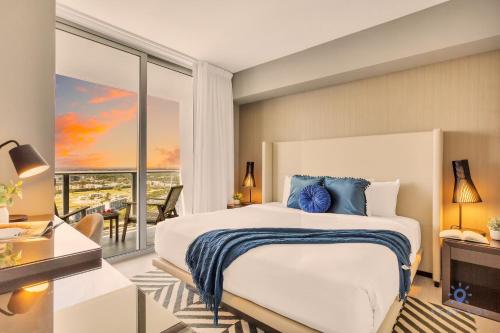 a bedroom with a large bed and a balcony at Beach House Design in Hollywood