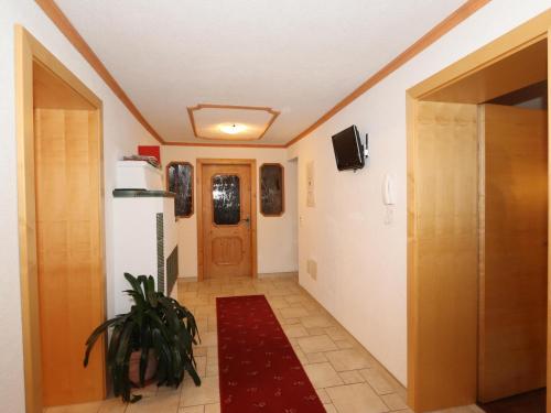 a hallway of a house with a door and a plant at Apartment Höllwarth in Thurmbach