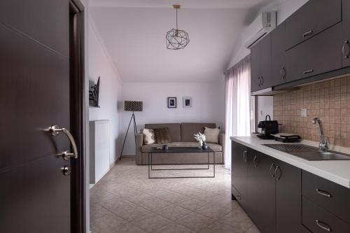 a kitchen and living room with a couch in the background at HOME WITH VIEW in Xanthi