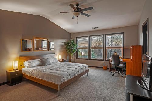a bedroom with a bed and a ceiling fan at Suburban Family Retreat - Outdoor Garden -sleep 10 in Duluth