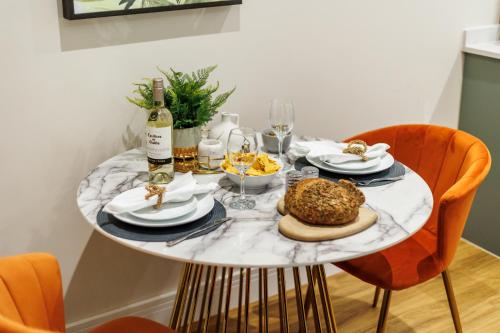 a table with food and wine on top of it at Sea Breeze - Coast in Bournemouth