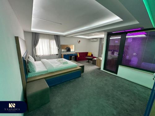 a bedroom with a bed and a living room at X SAPANCA OTEL in Sakarya