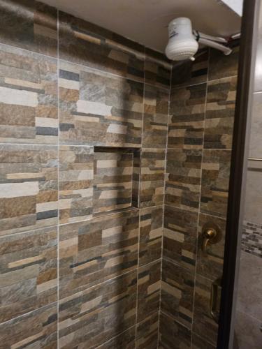 a bathroom with a shower with a glass door at Blanca Apartments in Guayaquil