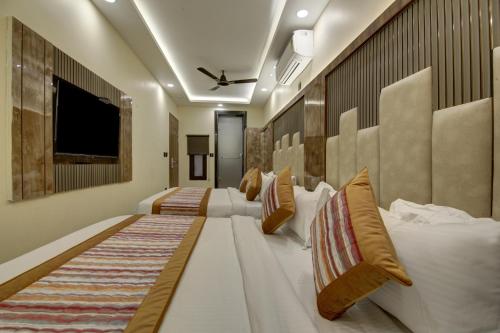 a hotel room with two beds and a tv at BLESS INN - Near Connaught Place in New Delhi