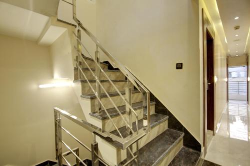 a staircase in a house with a metal railing at BLESS INN - Near Connaught Place in New Delhi