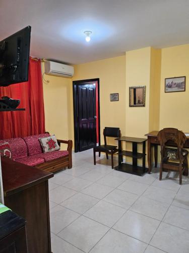 a living room with a couch and a table at Blanca Apartments in Guayaquil