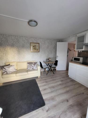 a living room with a couch and a table at The apartment in Saint-Rabier