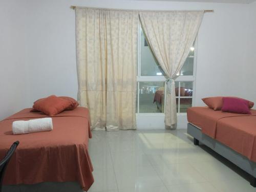 a bedroom with two beds and a window at PELICAN TOURS in Puerto Baquerizo Moreno