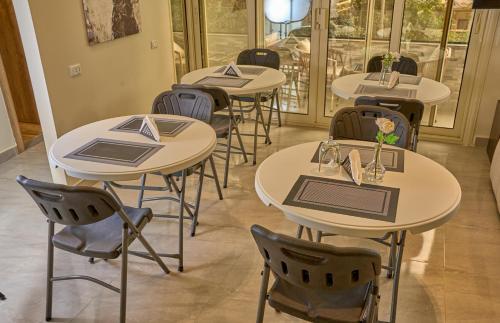 a row of tables and chairs in a restaurant at Lotus Inn in Cairo