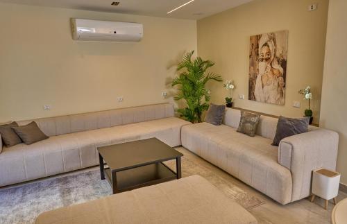 a living room with two couches and a table at Lotus Inn in Cairo