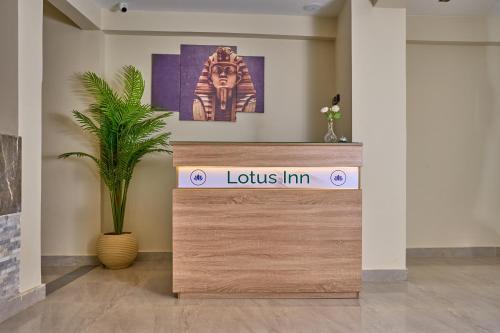 a reception desk in a room with a plant at Lotus Inn in Cairo