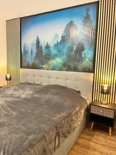 a bedroom with a large painting on the wall at Auszeit am Berg in Lenzkirch