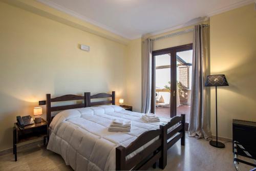 a bedroom with a large bed and a large window at The Life in Marcellina