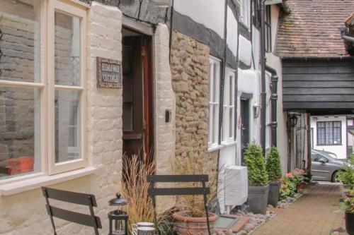 a bench sitting in front of a building at Hideaway Cottage in Ludlow