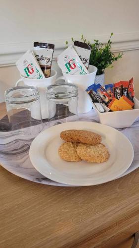 a table with a plate of food and some snacks at Church Farm Guest House in Horsford
