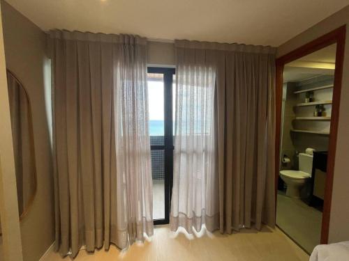 a bathroom with a window with a view of the ocean at Paradise Flat in Natal