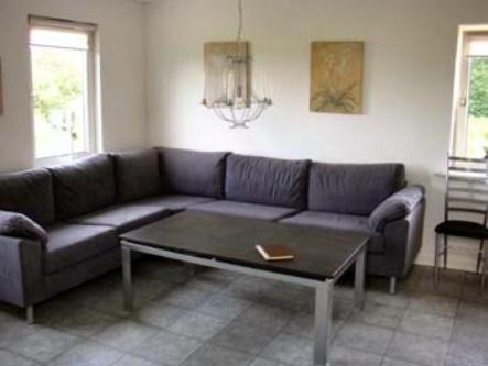 a living room with a couch and a coffee table at Billund countryside Appartement in Give