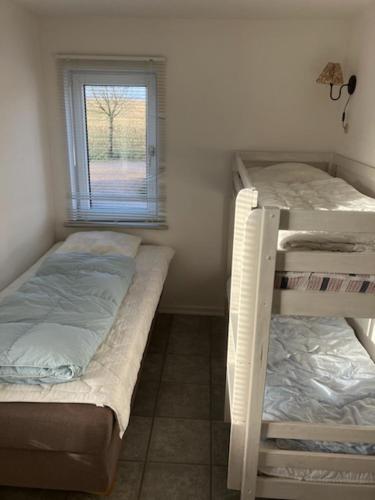two bunk beds in a room with a window at Billund countryside Appartement in Give