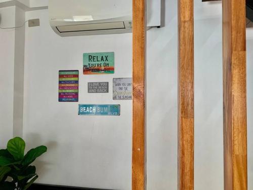 a white wall with signs on it at Samantha's Cove Priv Beach House in Oslob