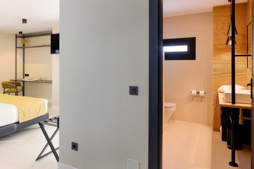 a room with a bed and a bathroom at Nuvō Hotel Boutique in Oviedo