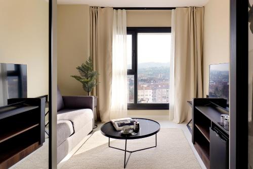 a living room with a couch and a table at Nuvō Hotel Boutique in Oviedo