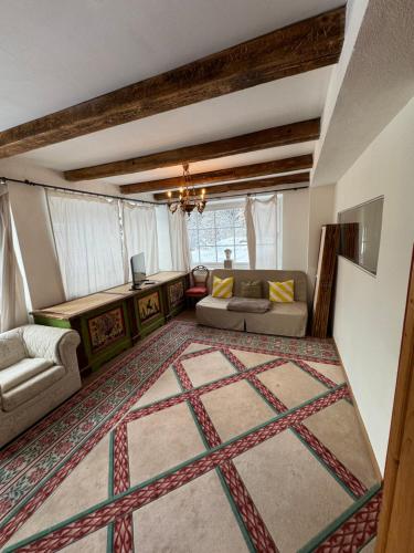 a living room with a couch and a rug at Fürstliches Appartement in Reith bei Kitzbühel in Reith bei Kitzbühel