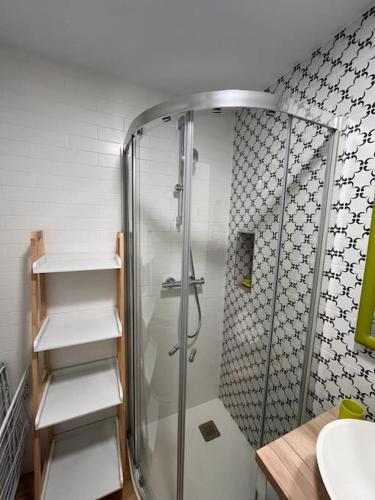a bathroom with a shower and a sink at Terraza Bolingas in Comillas
