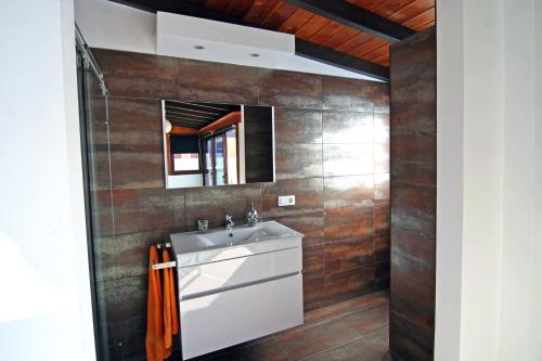 a bathroom with a sink and a mirror at Crystalsuite. Beautiful penthouse with sea views in Corralejo