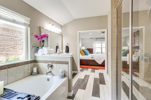 a bathroom with a bath tub and a bedroom at Covered Patio and Yard Spacious Leander Home! in Leander