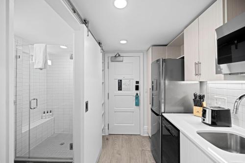 a kitchen with a sink and a refrigerator at Placemakr Dupont Circle in Washington