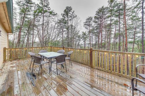 a wooden deck with a table and chairs on it at Talking Rock Home with Private Deck in Jasper