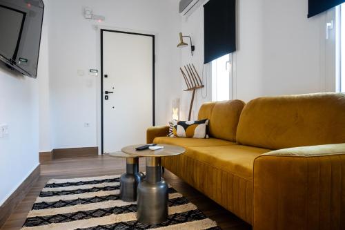 a living room with a couch and a table at Arion Aegli in Agioi Theodoroi