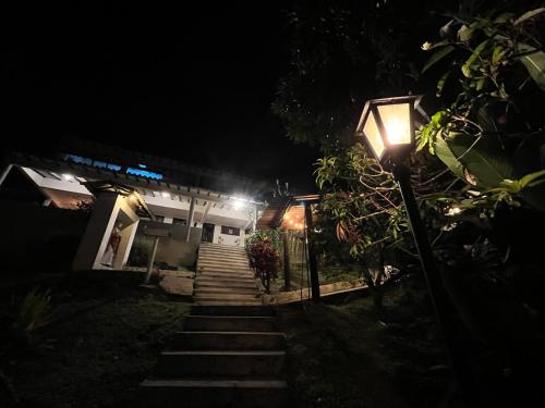 a stairway leading to a building at night at Palmeras del Mirador - Hotel Boutique Campestre en La Vega a 1h de Bogotá in La Vega