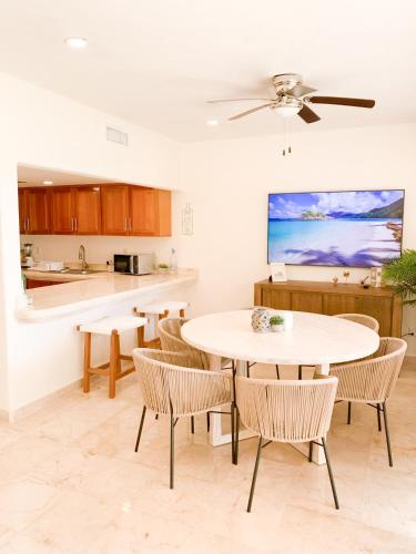 a kitchen and dining room with a table and chairs at Beachfront Breathtaking Views Puerto Aventuras in Puerto Aventuras