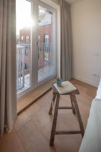 a coffee table in a room with a large window at Appartement 7 op de zeedijk in Knokke voor max 6 personen in Knokke-Heist