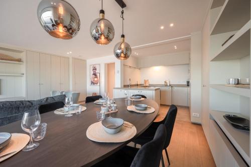 a dining room and kitchen with a table and chairs at Appartement 7 op de zeedijk in Knokke voor max 6 personen in Knokke-Heist