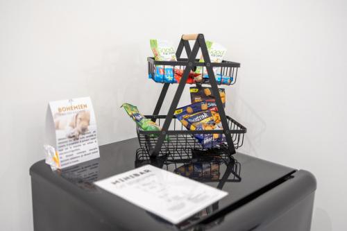 a black shelf with snacks on top of a refrigerator at Bohémien Boutique Guesthouse in Cefalù