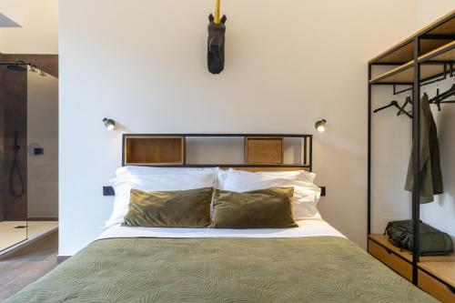a bedroom with a large bed with white pillows at Bohémien Boutique Guesthouse in Cefalù