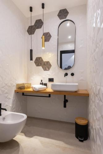 a bathroom with a sink and a mirror at Bohémien Boutique Guesthouse in Cefalù