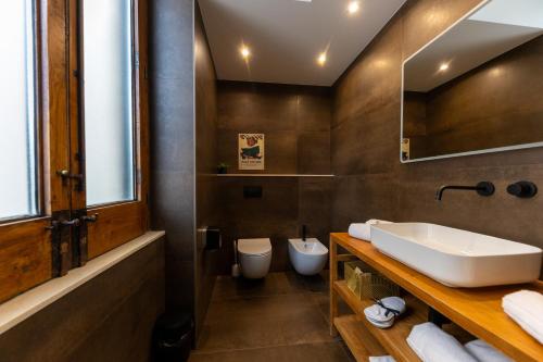 a bathroom with a sink and a toilet at Bohémien Boutique Guesthouse in Cefalù